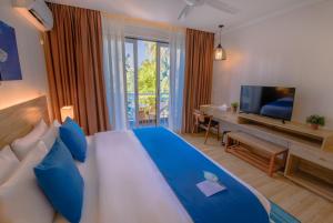 Postel nebo postele na pokoji v ubytování Dhiguveli Maldives