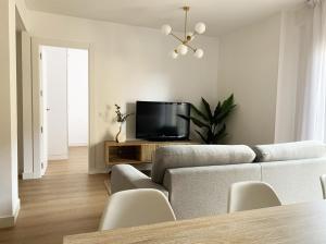 a living room with a couch and a tv at Casa Condes de Gómara in Soria