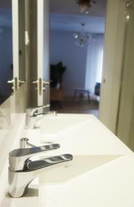 a bathroom sink with a faucet and a mirror at Casa Condes de Gómara in Soria +28 photos