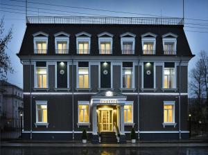 a large black building with a clock on it at Premium Hotel Pushkin in Angarsk