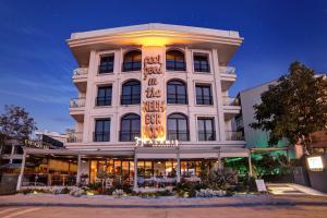 a large white building with a sign on it at 39 Kalamış Marina Hotel & Restaurant in Istanbul