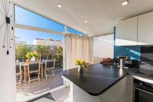 a kitchen with a view of a patio with a table at La Terrasse du Port AP4212 in Nice