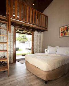 a bedroom with a bed and a loft bed at PANAMA CAMPING PARK in Bajo Boquete