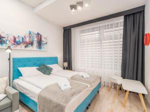 Posteľ alebo postele v izbe v ubytovaní ApartmentyPrzyMorzu Ogrody