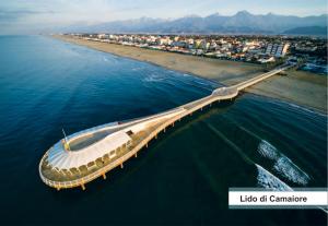 eine Brücke im Wasser neben einem Strand in der Unterkunft Hotel Europa in Lido di Camaiore