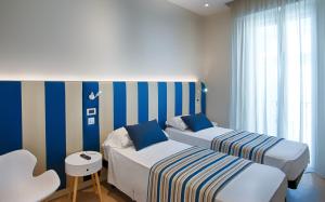 Łóżko lub łóżka w pokoju w obiekcie Hotel Agostini