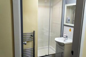 a bathroom with a shower and a sink at Lymedale Suites Studios & Aparthotel in NEWCASTLE UNDER LYME & STOKE in Newcastle under Lyme