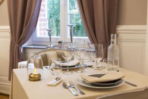 a table with wine glasses and a candle on it at Domaine Les Tilleuls in Wailly-Beaucamp