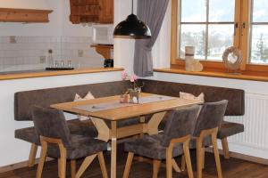 a dining room table and chairs in a kitchen at Landhaus Patricia in Ellmau