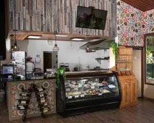 a bakery with a counter with a lot of food at Panama Camping Park Boquete in Boquete