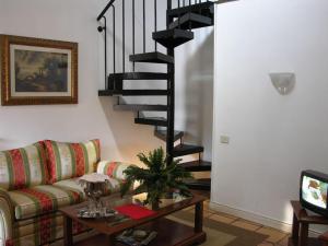 a living room with a couch and a spiral staircase at Residenza Monti in Rome