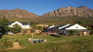 an aerial view of a house with mountains in the background at Raptor Rise in Tulbagh