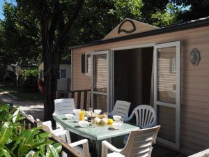 a table and chairs in front of a shed at LE CASQUE ROI in Salavas