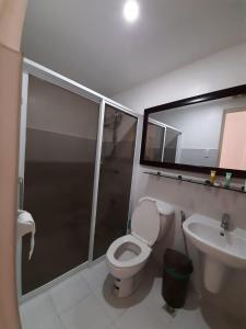 a bathroom with a shower and a toilet and a sink at Affordable Makati APT in Manila