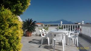 a white table and chairs on a balcony at Haus Despina in Sarti
