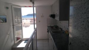 a small kitchen with a sink and a window at Haus Despina in Sarti