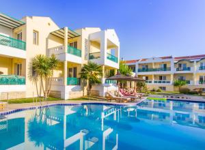 eine Villa mit einem Pool vor einem Gebäude in der Unterkunft Aegean Sun Hotel in Skala Rachoniou