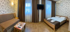 a hotel room with a bed and a couch at Hotel LaMa 2 in Kyiv