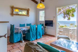 a living room with a table with chairs and a television at Appartements L'Acacia - plage d'Argent à 300m in Coti-Chiavari