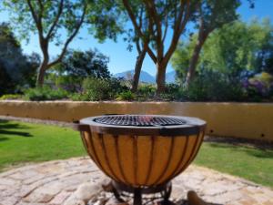 a grill in a yard with trees in the background at Villa Tarentaal in Tulbagh