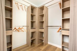 a walk in closet with wooden shelves at Grand appartement avec 3 salles de bain in Tourcoing