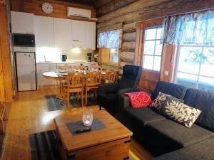 a living room with a couch and a table at Otsontupa Apartment in Ruka