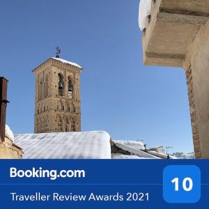 a clock tower with a cross on top of it at La Casa de Jabe - Toledo Casco Antiguo in Toledo