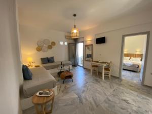 a living room with a bed and a living room with a couch at CAELI PAROS by Kostas & Joanna Studios in Logaras