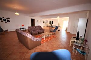 a living room with a couch and a table at Villa Olive in Loulé