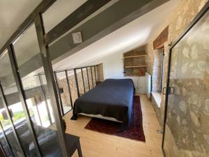 a bedroom with a bed on a balcony at Le Roet in Sisteron