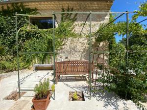 a swing in a garden with some plants at Le Roet in Sisteron
