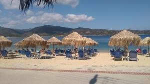 a group of people sitting in chairs on a beach at Haus Despina in Sarti