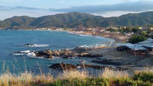 a view of a beach with a town and mountains at Haus Despina in Sarti