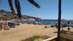 a beach with chairs and umbrellas and the ocean at Haus Despina in Sarti
