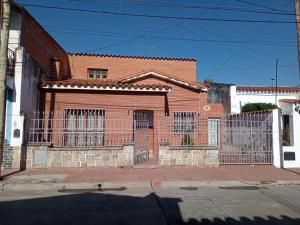 a brick house with a gate in front of it at Lo de Su in Salta