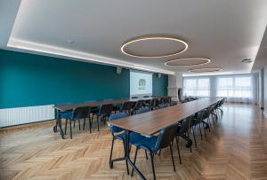 a conference room with a long table and chairs at Hotel Mezaparks in Rīga