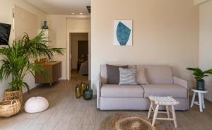 a living room with a couch and some plants at Prima Vista Boutique Hotel & Spa in Sivota