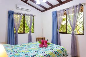 Ένα ή περισσότερα κρεβάτια σε δωμάτιο στο Bungalows Ache Cozy House