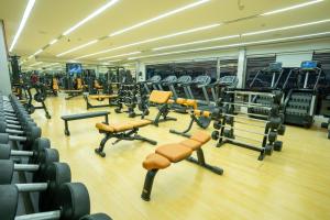 a gym with a bunch of treadms and machines at Elite Seef Residence And Hotel in Manama