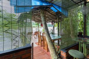 a room with a tree inside of a building at Munkudil Ayurveda & Yoga Retreat in Kuttampuzha