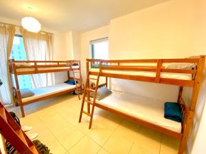 a room with two bunk beds at DXB Backpackers in Dubai