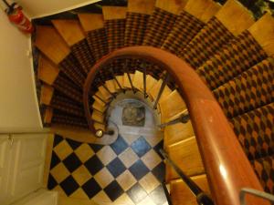 an overhead view of a spiral staircase in a room at Hôtel du Vieux Marais in Paris