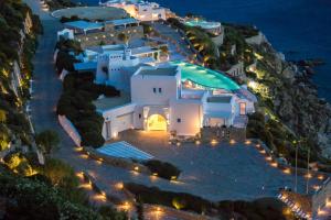 an aerial view of a building on a cliff at night at AGL Luxury Villas in Mikonos