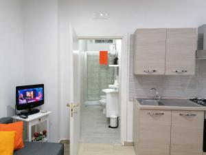 a small kitchen with a sink and a toilet at QUIET HOUSE GARDEN NAPLES-POMPEI-SORRENTO in Trecase +13 photos