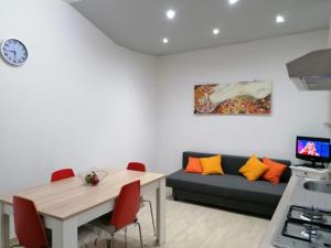 a living room with a couch and a table at QUIET HOUSE GARDEN NAPLES-POMPEI-SORRENTO in Trecase