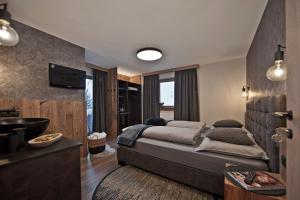 a bedroom with a large bed and a bathroom at Villa Michaela in Gerlos