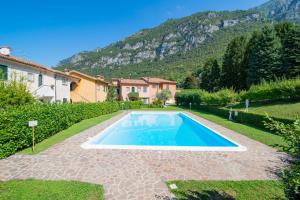 a swimming pool in the yard of a house at SARA E MELISSA HOUSE LIERNA in Lierna