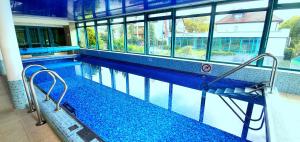 an empty swimming pool in a building with windows at SPA Barlinek, Hotel Alma MED & SPA in Barlinek +44 photos