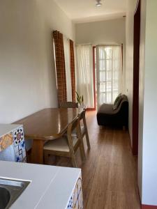 a living room with a wooden table and a chair at Doroteo's Transient House in Calingcuan