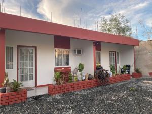 a small house with a red roof at Doroteo's Transient House in Calingcuan